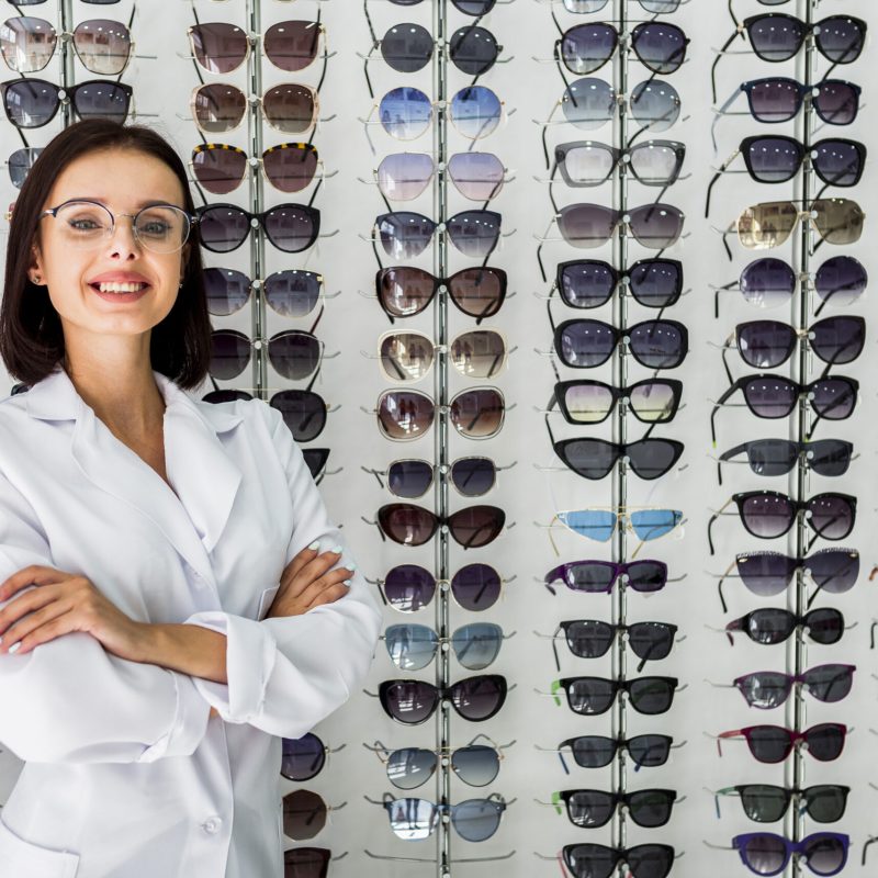 medium-shot-optician-with-sunglasses-display